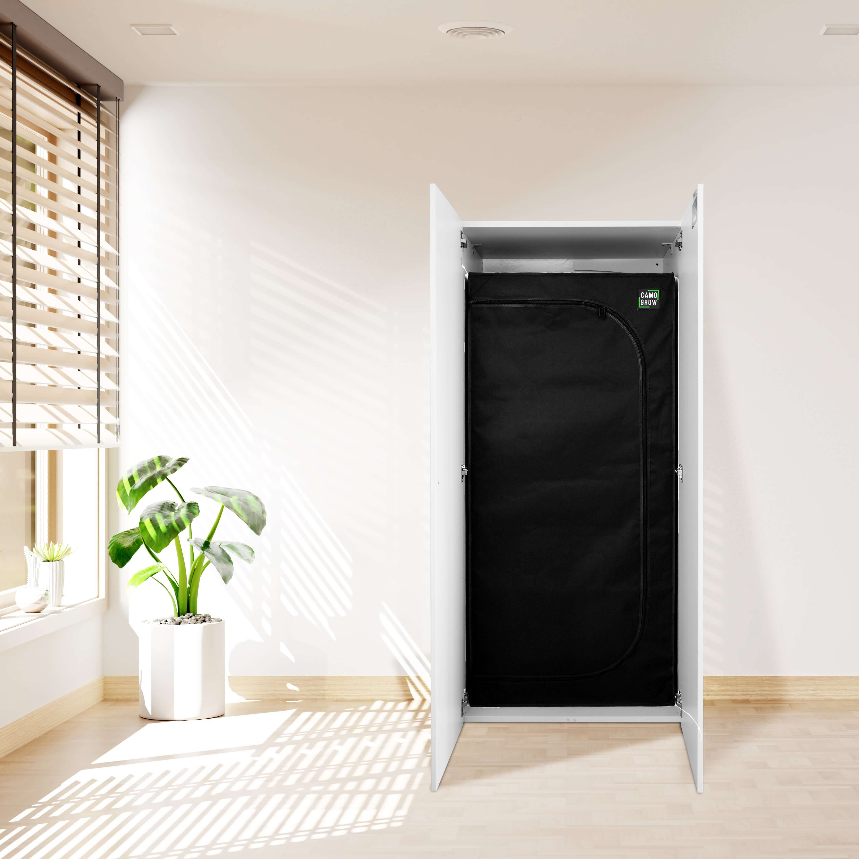 Modern closet with black garment cover, featuring natural light and indoor plants for a stylish home decor.