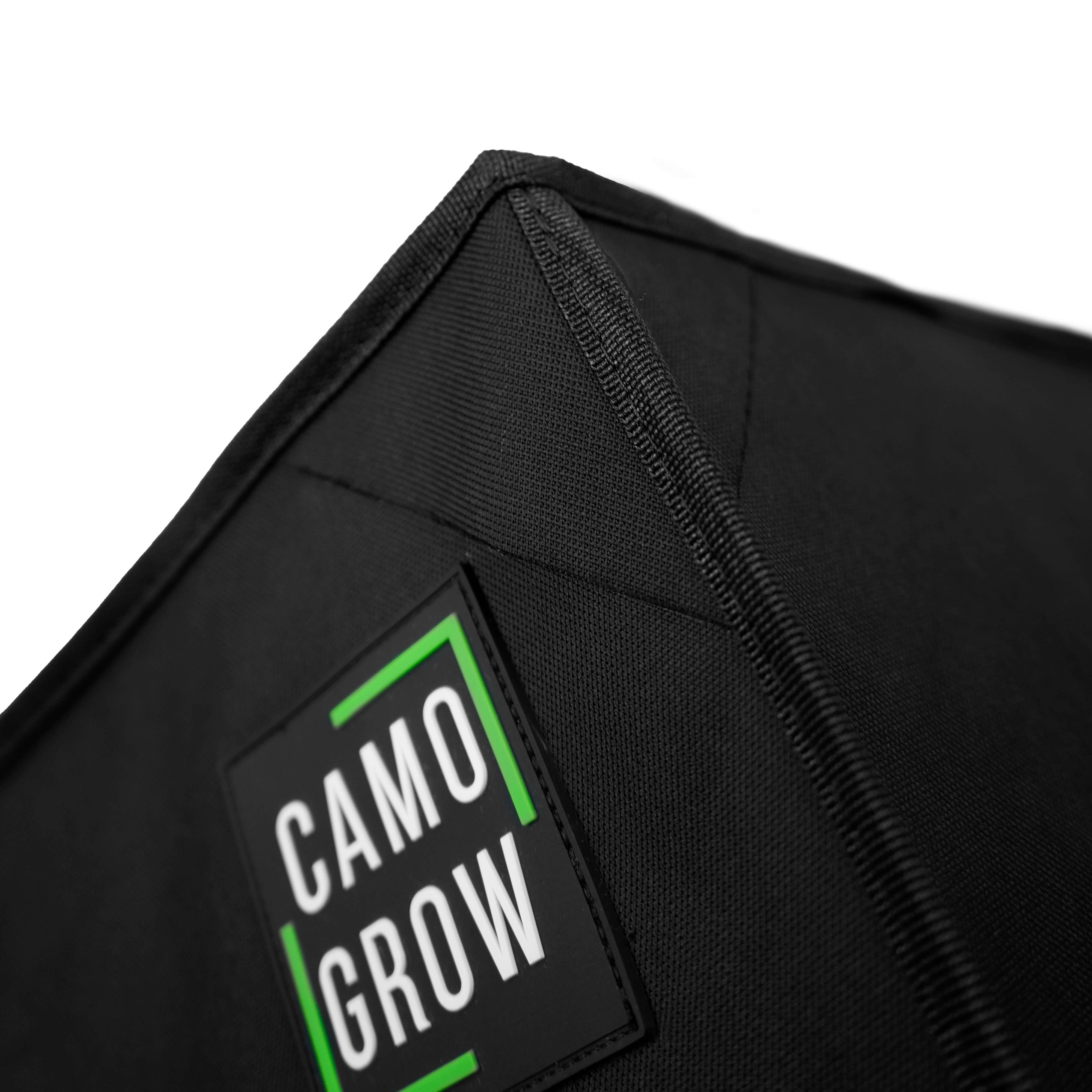 Close-up of a black fabric grow tent with CamoGrow logo and stitching details.
